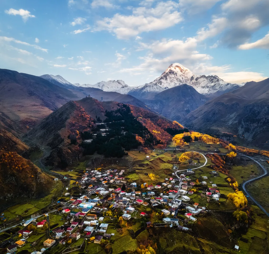 Stepantsminda or Kazbegi with Mount Kazbeg at sunrise, Georgia